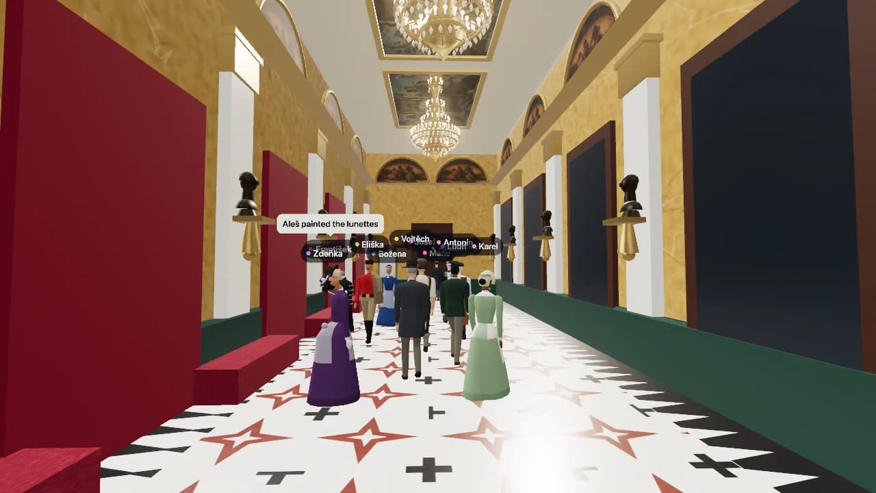 The foyer of the National Theatre in Prague as a 3D model: a long hall with a white and red star-patterned floor, gilded walls, chandeliers and painted ceiling panels, where a dozen figures in dresses, frock coats and top hats of the 1880s stand talking, each with a name plate above the head and two with speech bubbles