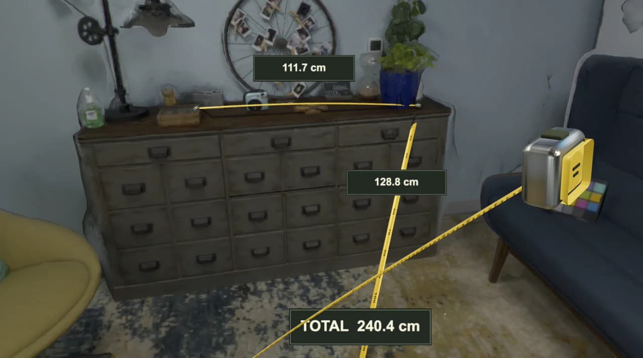 A measuring tape drawn across the floor of a scanned living room, seen through an emulated headset